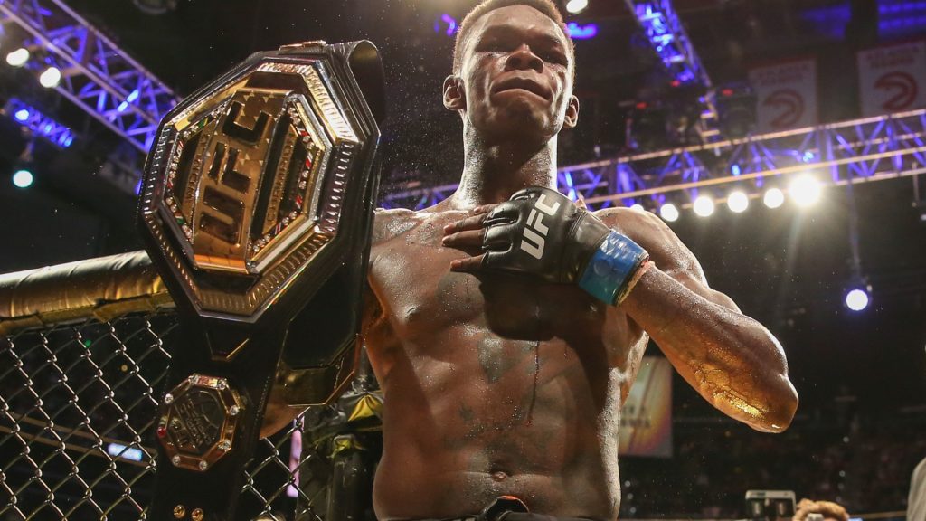 israel-adesanya-holds-belt-defeating-607625963.jpg